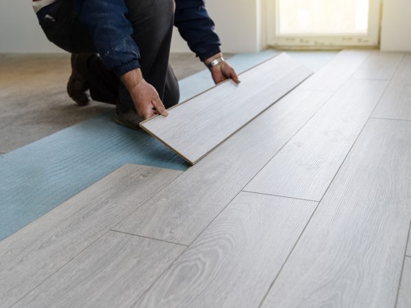 Worker carpenter doing laminate floor work